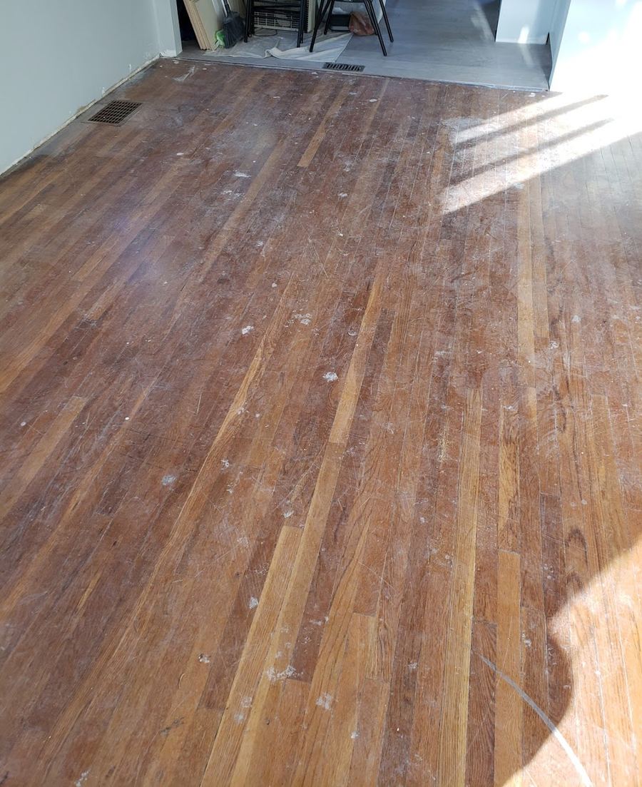 Oak floor before refinishing, with worn, patchy finish