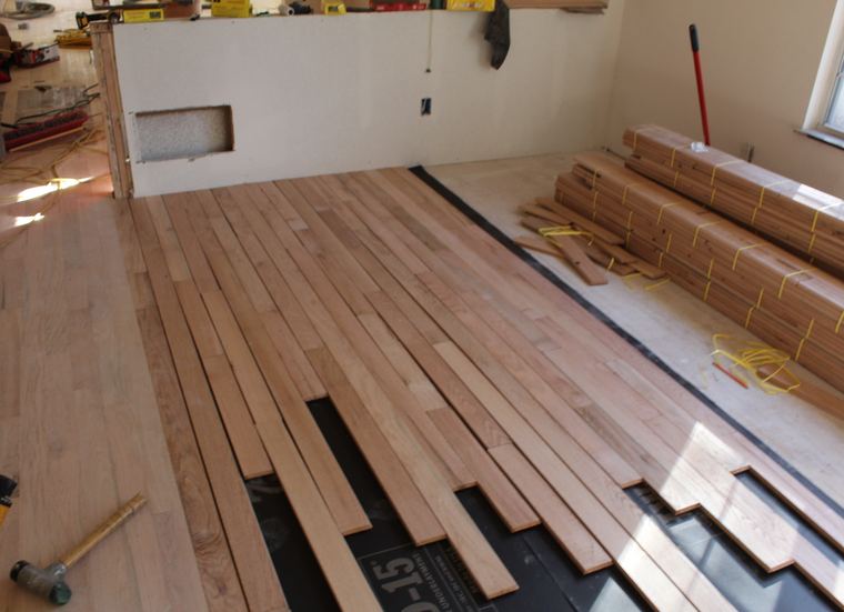 New unfinished hardwood boards being installed