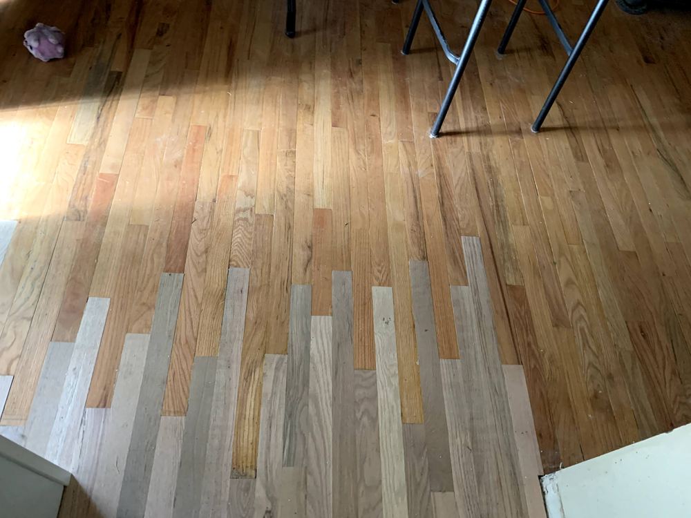 Hardwood floor with a mix of light and dark planks
